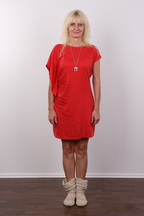 Older blonde Ivana doffs a red dress and winter boots for her first nudes
