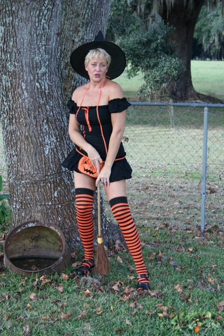 Older lady Tracy Lick shows her bald twat while riding broomstick in backyard