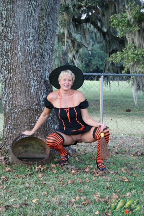 Older lady Tracy Lick shows her bald twat while riding broomstick in backyard