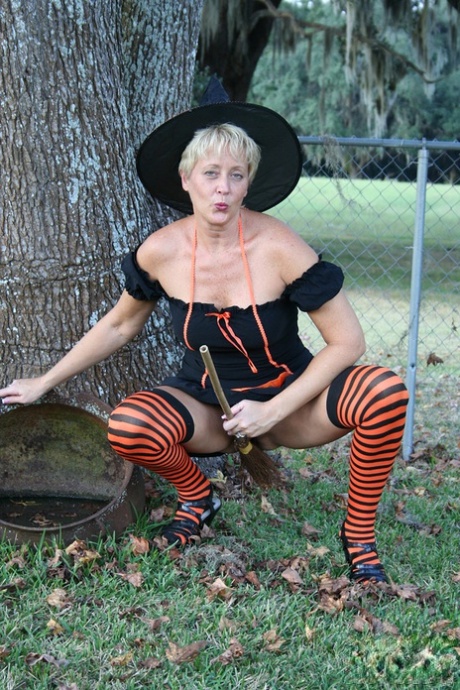 Older lady Tracy Lick shows her bald twat while riding broomstick in backyard