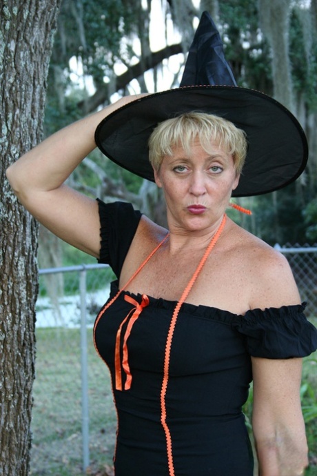 Older lady Tracy Lick shows her bald twat while riding broomstick in backyard