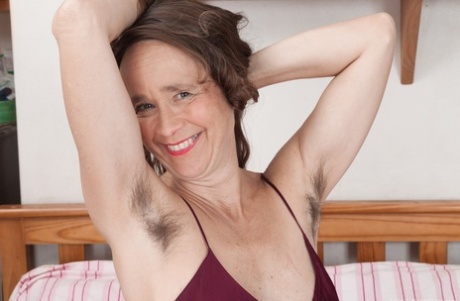 Older lady with big tits shows off her really hairy bush for the first time