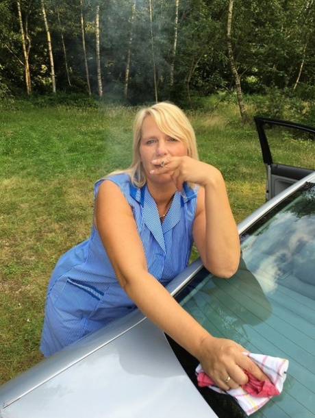 Smoking mature mom Sweet Susi opens her dress to pinch hard nipples outdoors