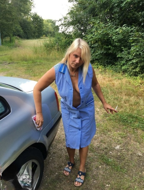 Smoking mature mom Sweet Susi opens her dress to pinch hard nipples outdoors