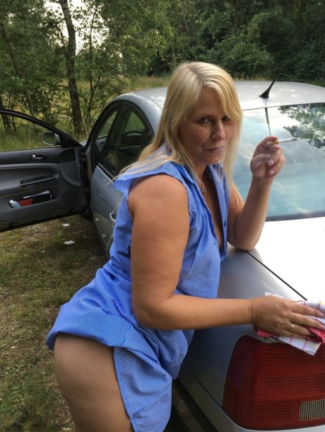 Smoking mature mom Sweet Susi opens her dress to pinch hard nipples outdoors