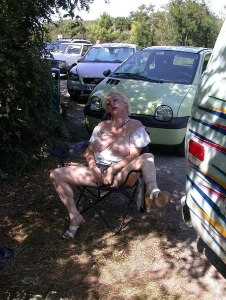 Older blonde amateur Mary Bitch takes a pee before going topless in the ocean