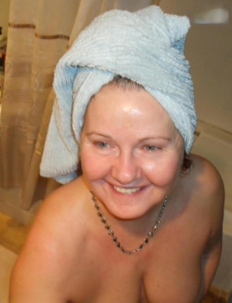 Mature lady Busty Bliss takes a cock in hand while showering at the same time