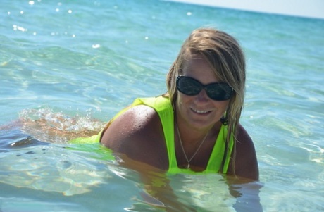Middle-aged blonde Sweet Susi exposes her ass and pussy while in the ocean