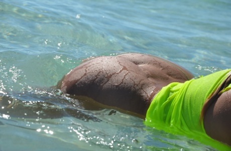 Middle-aged blonde Sweet Susi exposes her ass and pussy while in the ocean