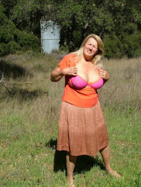 Old amateur Adonna bares her big tits and bald cunt with the sun in her eyes