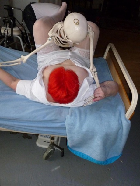 Older redhead nurse Valgasmic Exposed gets banged by a dildo wielding skeleton