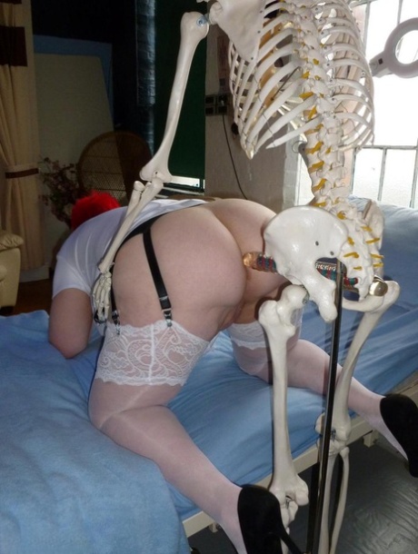 Older redhead nurse Valgasmic Exposed gets banged by a dildo wielding skeleton
