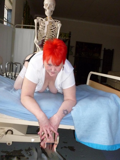 Older redhead nurse Valgasmic Exposed gets banged by a dildo wielding skeleton