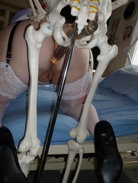Older redhead nurse Valgasmic Exposed gets banged by a dildo wielding skeleton