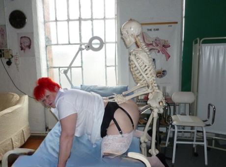 Older redhead nurse Valgasmic Exposed gets banged by a dildo wielding skeleton