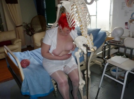 Older redhead nurse Valgasmic Exposed gets banged by a dildo wielding skeleton