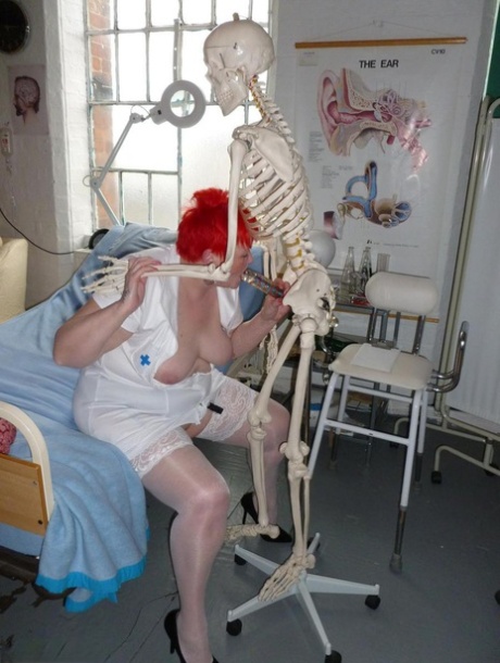 Older redhead nurse Valgasmic Exposed gets banged by a dildo wielding skeleton