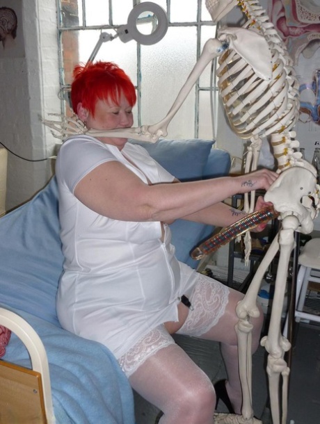 Older redhead nurse Valgasmic Exposed gets banged by a dildo wielding skeleton