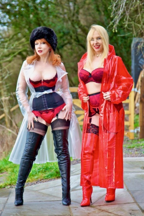 British lesbians expose boobs while modelling raincoats and thigh-high boots