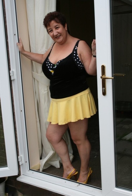 Fat older woman Kinky Carol flashes her bra and upskirt underwear on a patio