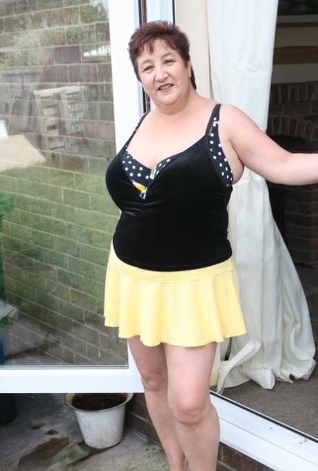 Fat older woman Kinky Carol flashes her bra and upskirt underwear on a patio