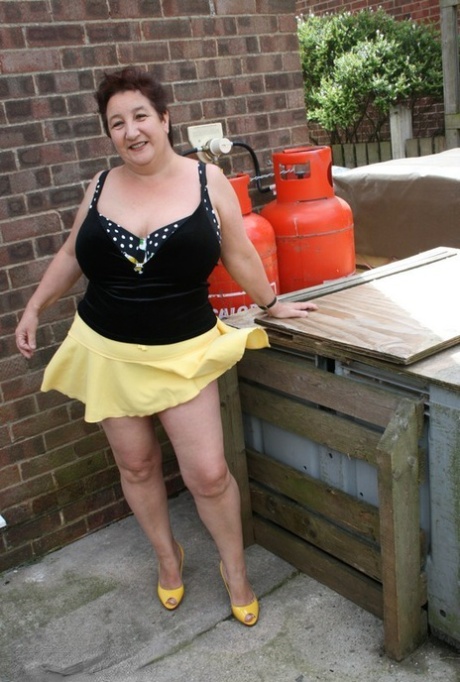 Fat older woman Kinky Carol flashes her bra and upskirt underwear on a patio