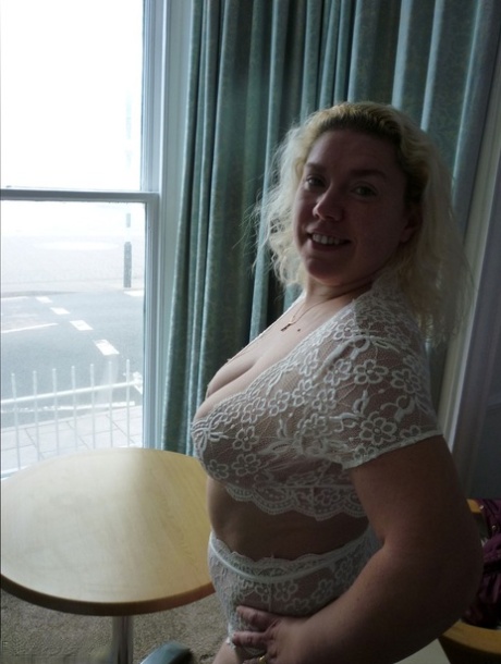 Mature blonde Barby fondles her big tits while masturbating during a shower