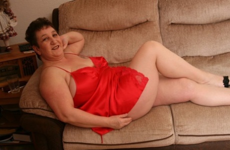 Overweight mature woman Kinky Carol releases her large tits from red lingerie