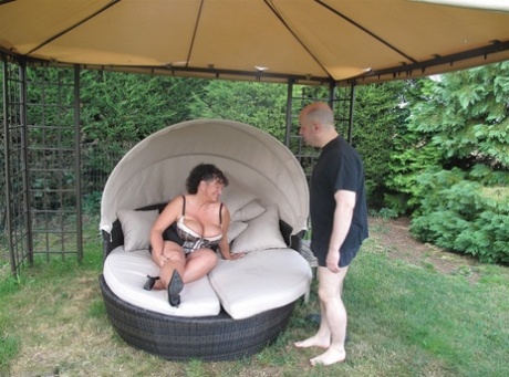 Mature lady and her man friend have sexual intercourse on lawn furniture