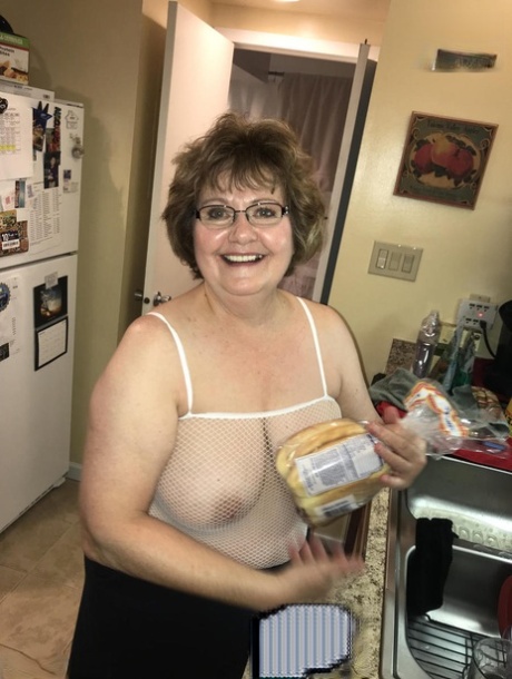Mature lady Busty Bliss has sex on a bed with her toy boy