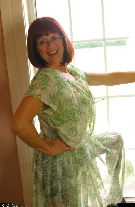 Horny mature redhead Miss Abigail gets topless for hot silk panty upskirt