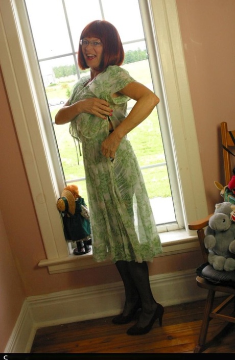 Horny mature redhead Miss Abigail gets topless for hot silk panty upskirt