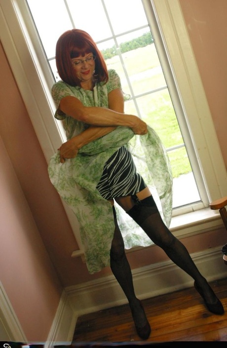 Horny mature redhead Miss Abigail gets topless for hot silk panty upskirt