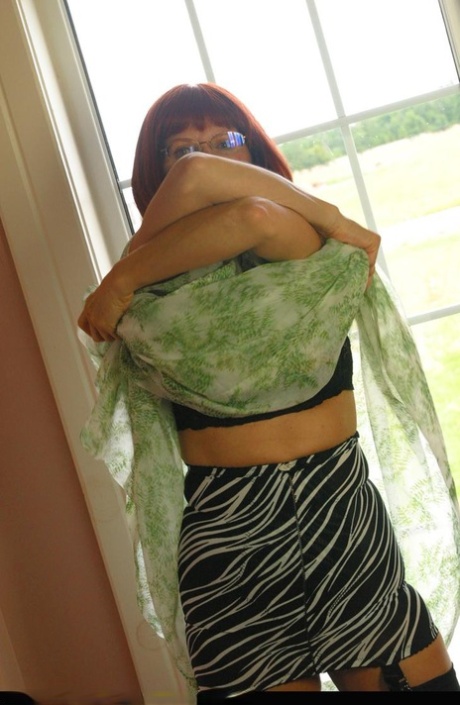 Horny mature redhead Miss Abigail gets topless for hot silk panty upskirt
