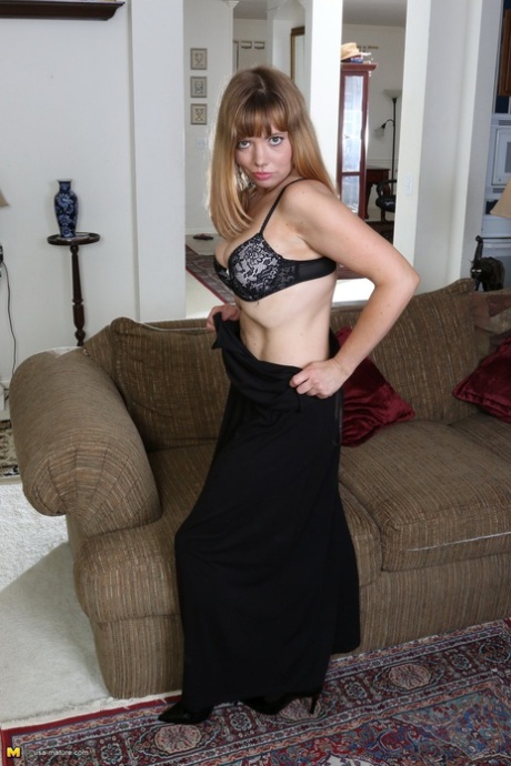 American housewife teasingly strips to black stockings in her living room
