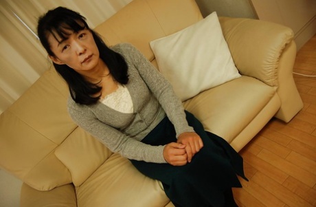 Tiny tits Asian mature Kiyoe Majima in a close up undressing scene