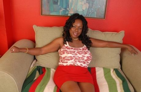 Fatty ebony Yvette shows her awesome big natural boobies on sofa
