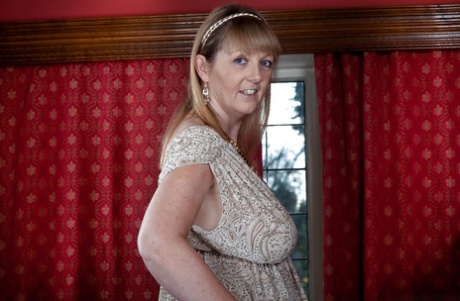 Sexy mature lady with huge boobs Sophie UK taking off her clothes
