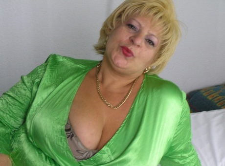 Naughty fat mature Lydia plays with her massive juggs and poses naked