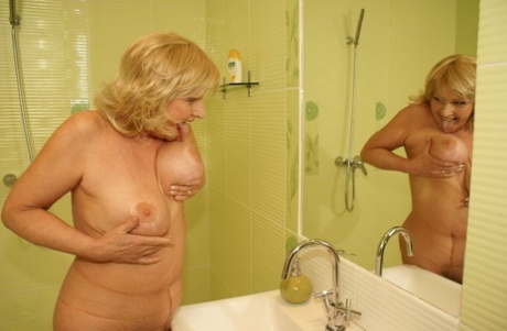 Blonde mature with a big ass Katalina strips and toys herself in the shower