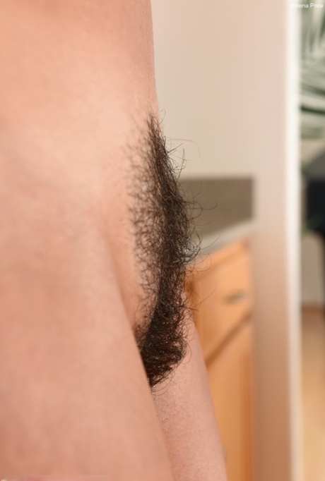 Sexy MILF Helena Price unveils her inviting hairy pussy in a hot kitchen strip