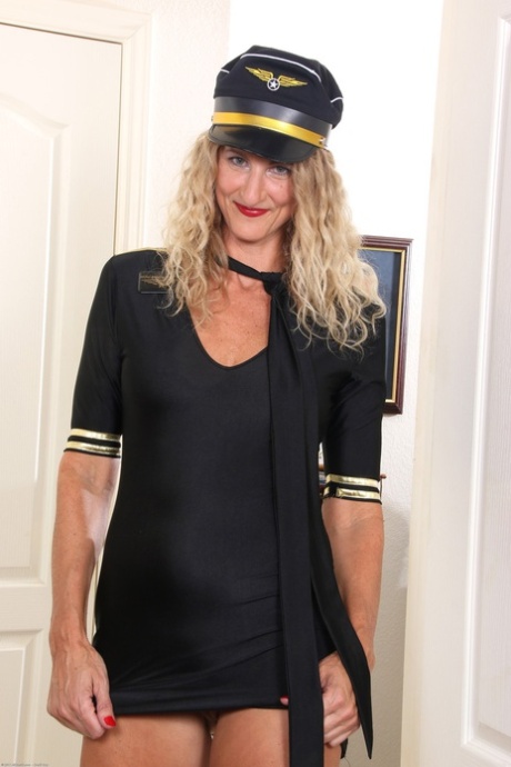 Flight attendant Layla Wolf unveils her trimmed pussy in a sexy striptease
