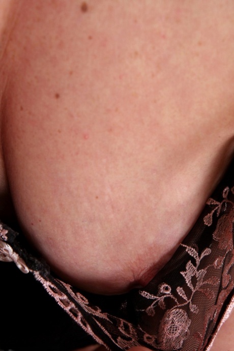 Gorgeous MILF Liz M spreads her hairy pussy up close after a sexy striptease