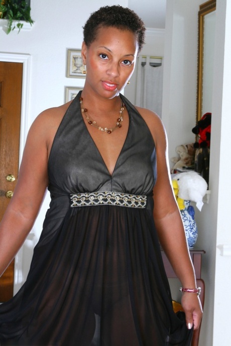 Short-haired ebony MILF Stacy J shows her bubble ass and shaved cunt in a solo