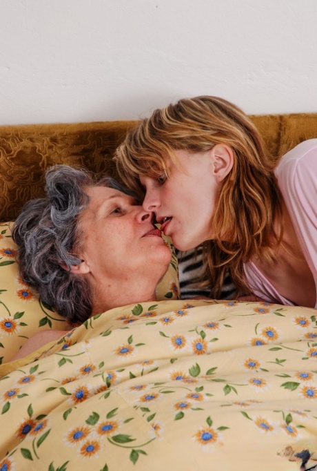 Grey haired granny Margoth and very hot busty teen Judita play with a strapon