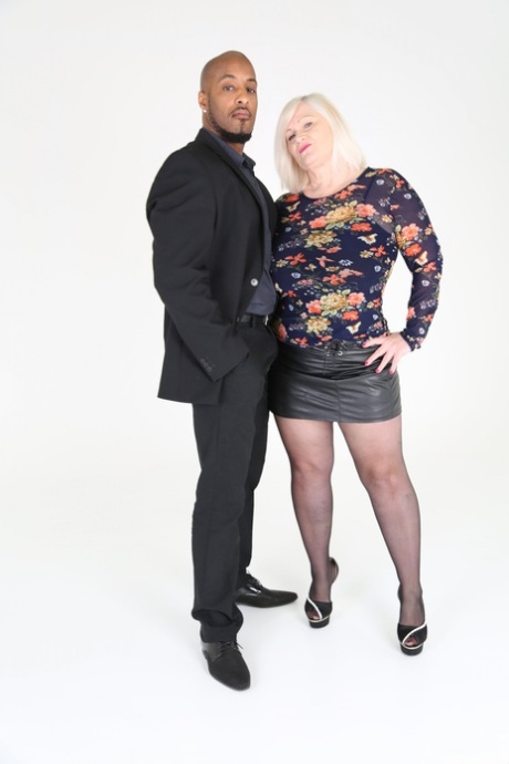 Blonde granny Lacey Starr eats a black cock before riding it in stockings