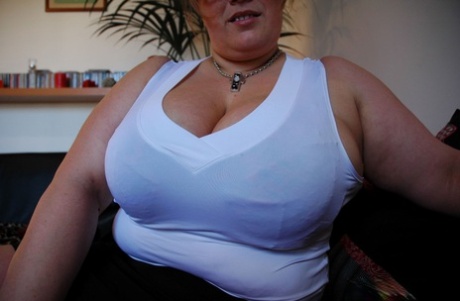 Curvy mature in glasses Kapucine lets out her huge breasts in a solo