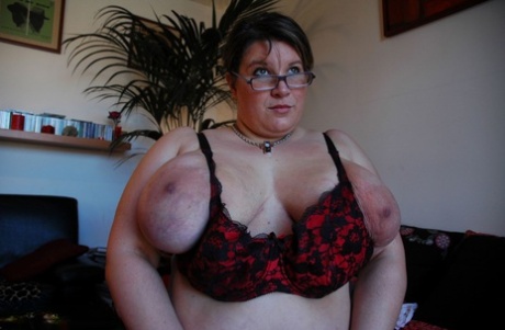 Curvy mature in glasses Kapucine lets out her huge breasts in a solo