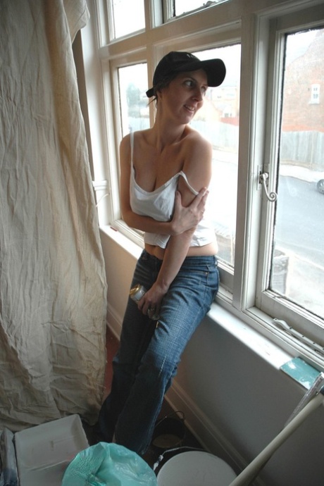 Amateur mature in a cap Kim squeezes her huge breasts and poses