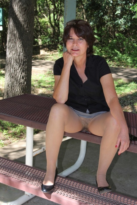 Mature European Carrie M. flashing her hairy vagina through sheer pantyhose